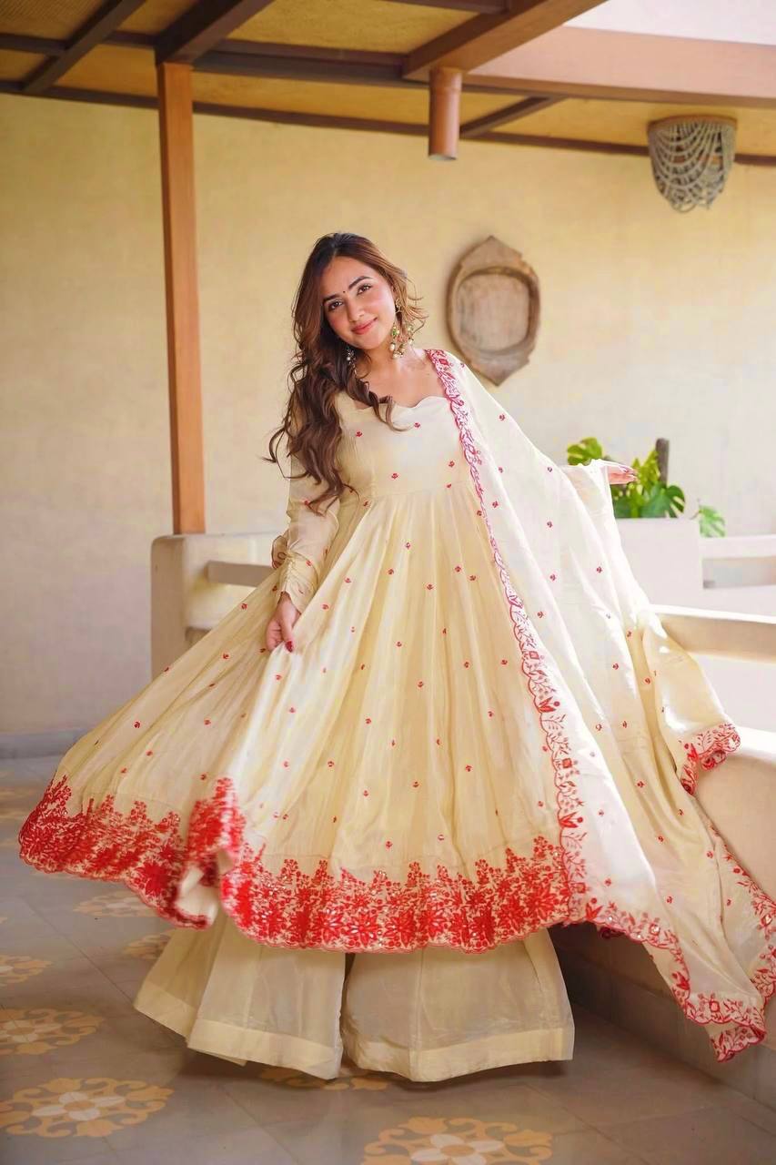 Exquisite Beige Flared Anarkali Suit Set Adorned with Vibrant Red Floral Embroidery, Sequined Scalloped Hem, and an Elegant Tie-Up Back